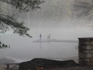 Fisherman in fog on Watoga Lake in February