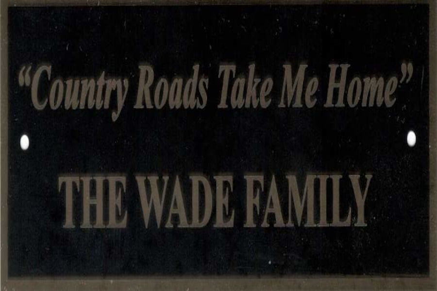 This image is displaying the Wade family's inscription on a plaque for a park bench located near the Fred E. Brooks Memorial at the Arboretum at Watoga State Park near Marlinton, West Virginia. The Wades have visited Watoga for decades. We love the inscription on the Wade's park bench and so would John Denver. | 📸: Watoga State Park Foundation, Inc.