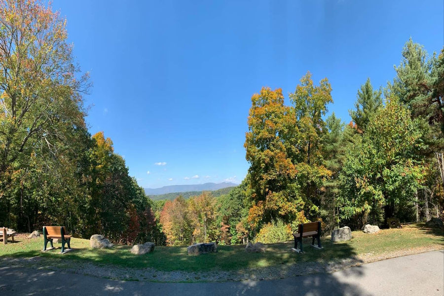 It's an early fall day with the leaves just starting to change, some yellows and oranges beginning to appear. You can pick your bench at T.M. Cheek overlook as you take in the panoramic view of the Greenbrier River Valley and Kennison Mountain in the distance. The bench on the left honors Alfred G. Dean, Jr. for "A Life Dedicated To WV State Parks." Junior's final service was as a board member on the Watoga State Park Foundation. The bench on the right was donated by the Foundation. Enjoy the view. | 📸: Watoga State Park Foundation, Inc.