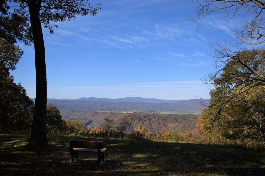 You can see for miles and miles with this fall scene. This is just one of the many stunning views at Ann Bailey Lookout Tower. In the distance are the Greenbrier River Valley and the Little Levels District of Pocahontas County. Bench was donated by the Young family. Photo by John Dean©.